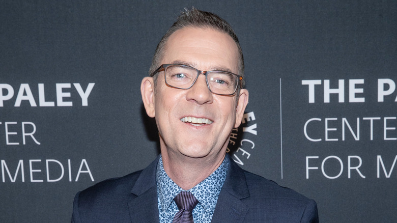 Food Network host Ted Allen smiles on a red carpet