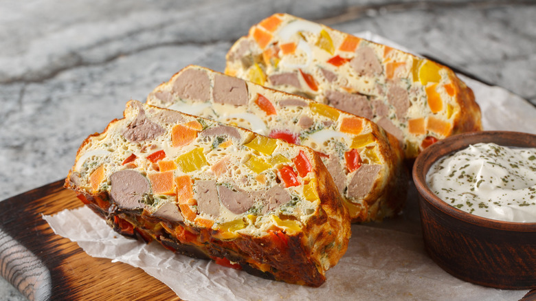Slices of chicken terrine on a wood board