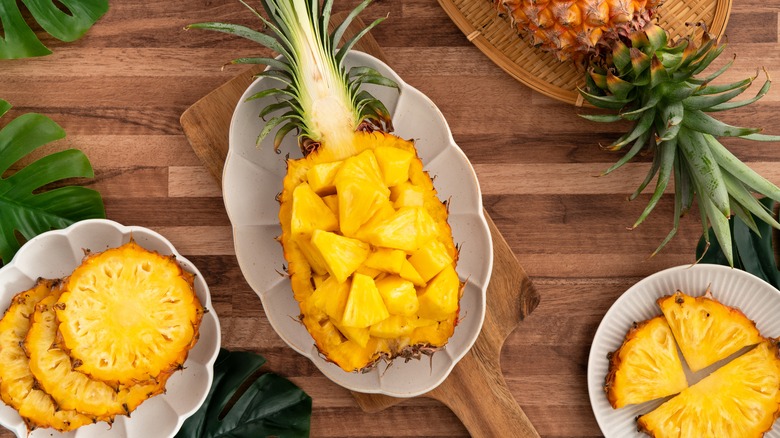 Pineapple chunks sitting inside a pineapple shell.