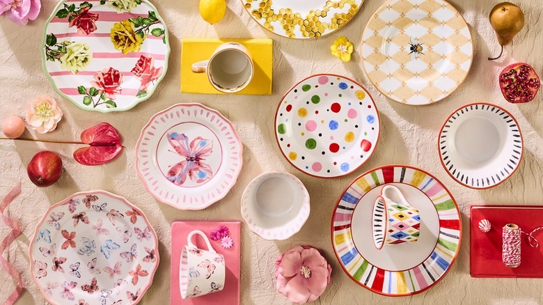 Colorful MacKenzie-Childs dishware displayed on table