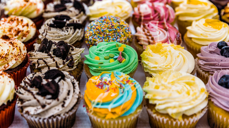 Variety of decorated cupcakes on a table