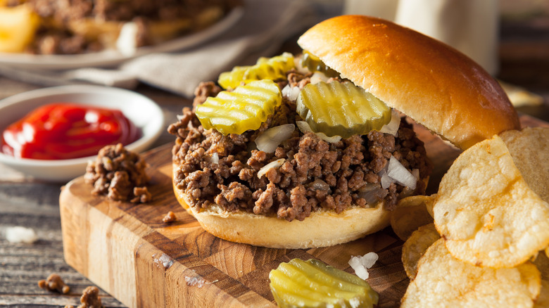 Loose meat sandwich on bun with pickles