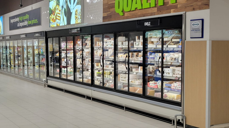 An empty aisle showing the refrigerated section of an Aldi