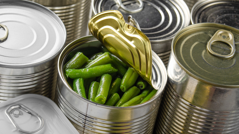 Metal can with lid peeled back to reveal green beans