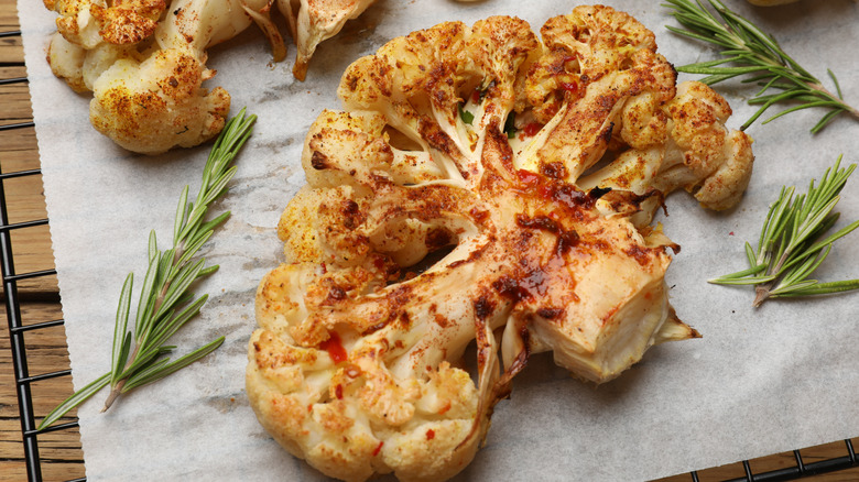 A roasted and spiced cauliflower floret on a baking sheet.