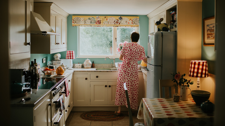 a woman in a vintage style kitchen