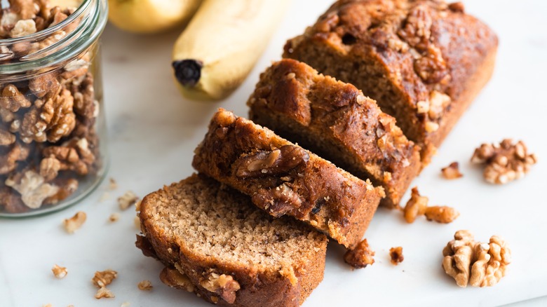 Sliced banana bread and walnuts