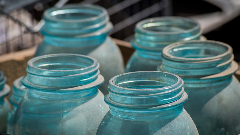 Close up of the tops of four old Jason Jars