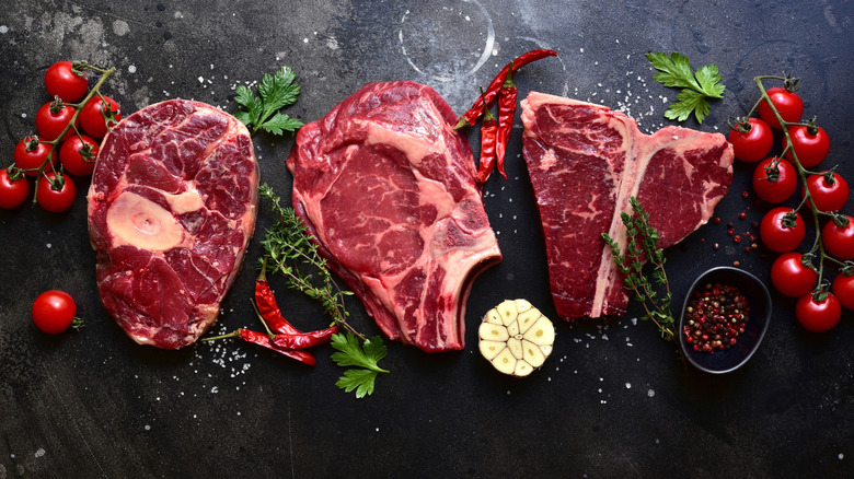 Raw steaks showing their various levels of marbling