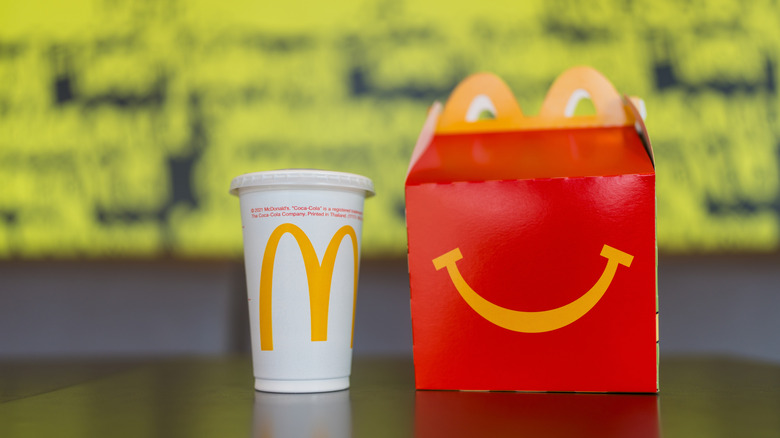 A Happy Meal box and a McDonald's soda sit together on a countertop