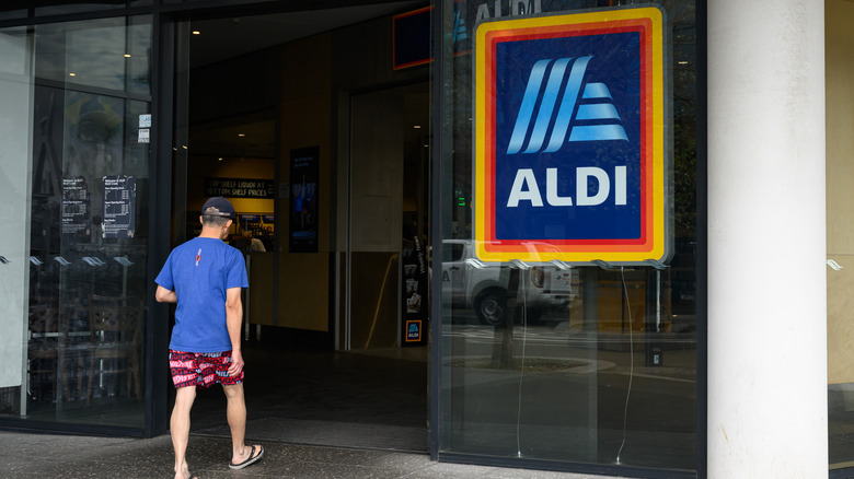Man walking into entrance of Aldi store