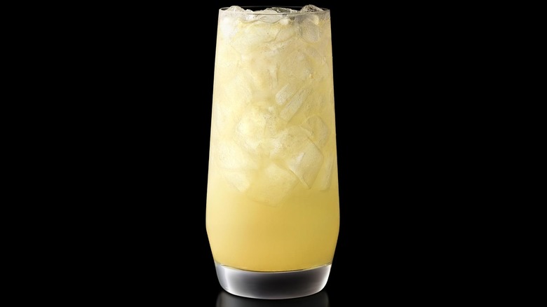 A glass of McDonald's new lemonade against a black background