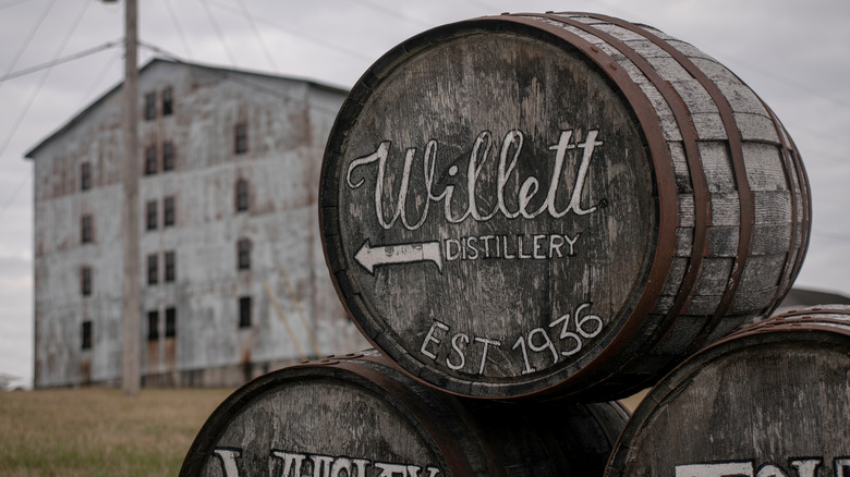Barrel pointing to Willett Distillery and old building in background