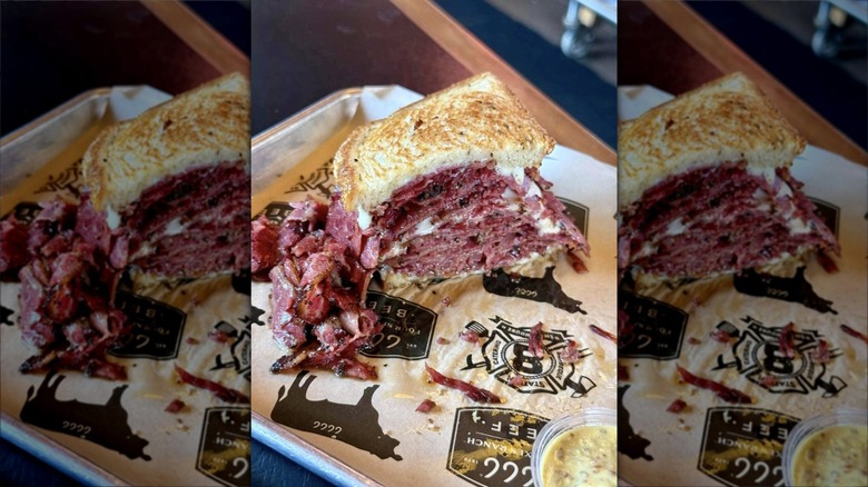 Half-eaten roast beef sandwich on tray