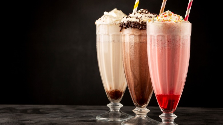 Vanilla, chocolate, and strawberry milkshakes in glasses