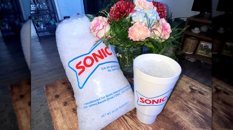 A bag of sonic ice with a cup and flowers