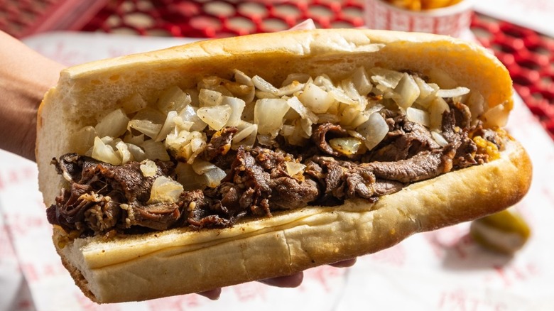 hand holding a cheesesteak