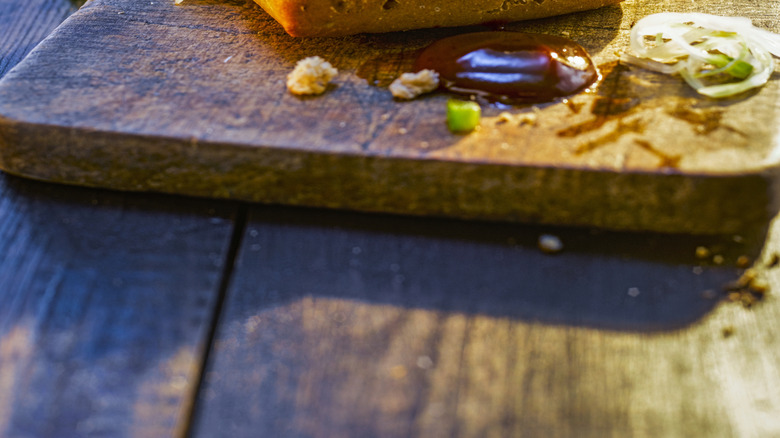 A large pub style burger topped with sauce and cooked cabbage