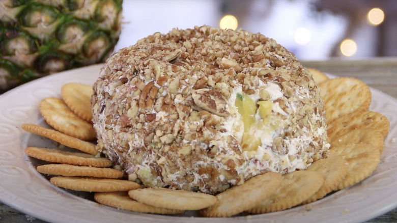 Pineapple cheese ball surrounded by crackers