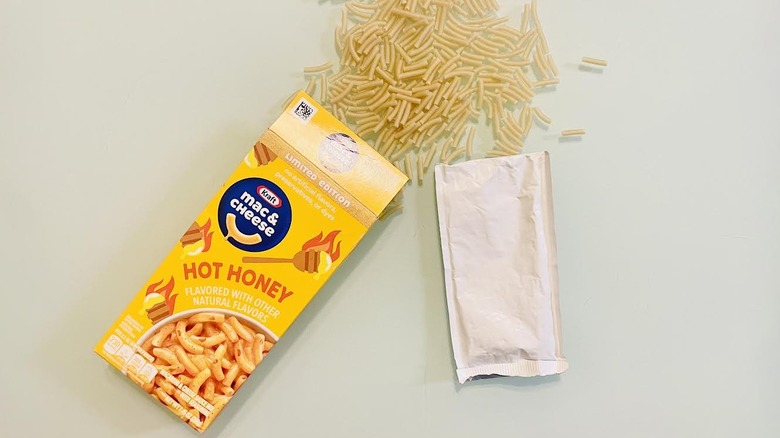 Spilled box of Kraft Hot Honey Mac & Cheese with cheese packet