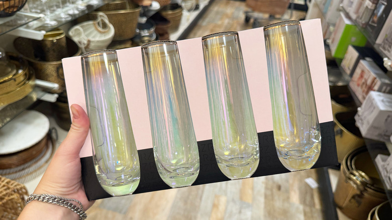 Rachel Zoe stemless champagne glasses are held up by a hand