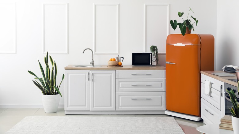 a retro refrigerator in a white kitchen