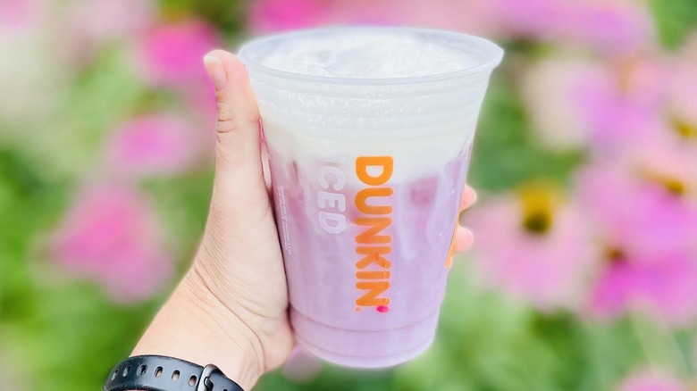 Hand holding new Mixed Berry Daydream Refresher from Dunkin'
