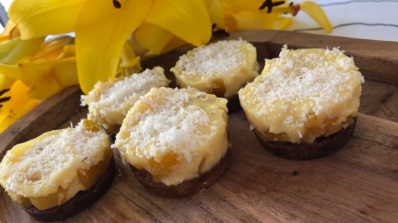 pina colada bites next to bright yellow flowers