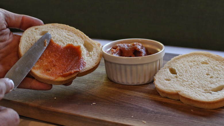 spreading apple butter on bread