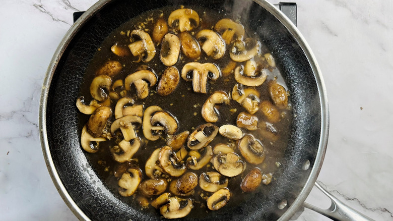 mushrooms and liquid in frying pan