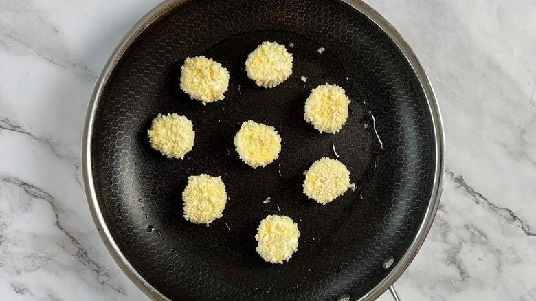 Breaded goat cheese slices in pan
