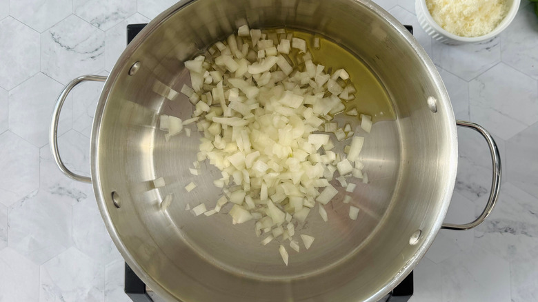 diced onions in pot with oil