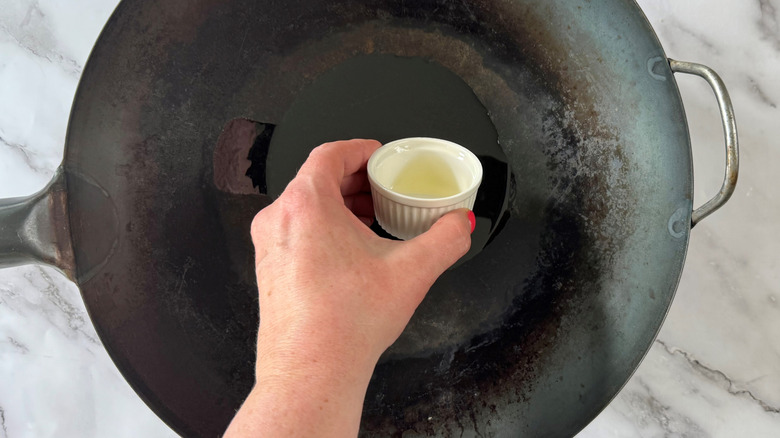 pouring oil into wok