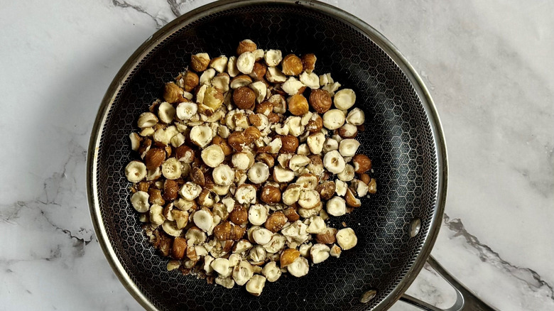 Crushed hazelnuts in pan