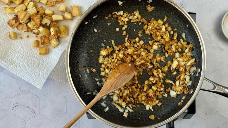 chopped onions in black frying pan