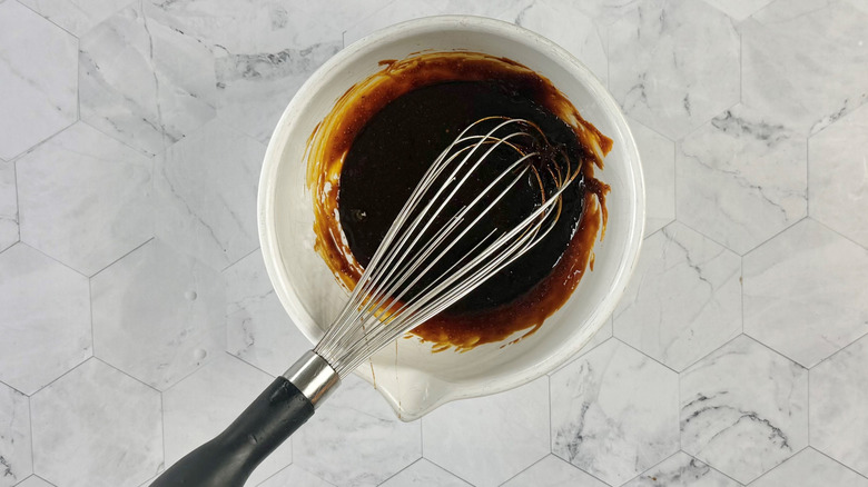 whisking sugar, molasses, and seasonings in bowl