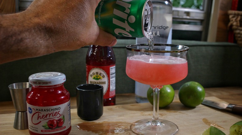 soda pouring into cocktail