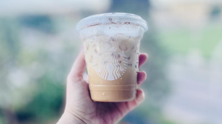Hand holding Starbucks Just add mocha drink
