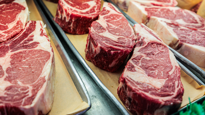 Display case filled with steaks on butcher paper