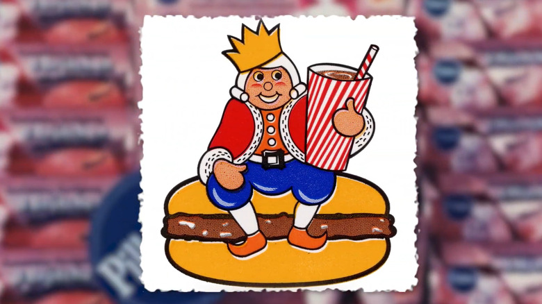 Cartoon image of Burger King king sitting on top of a giant burger and holding a giant drink