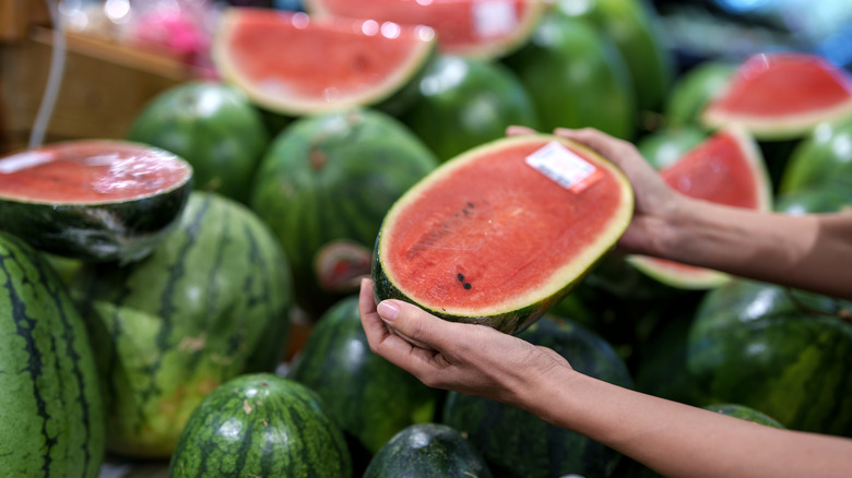 Person shopping for watermelon at the store