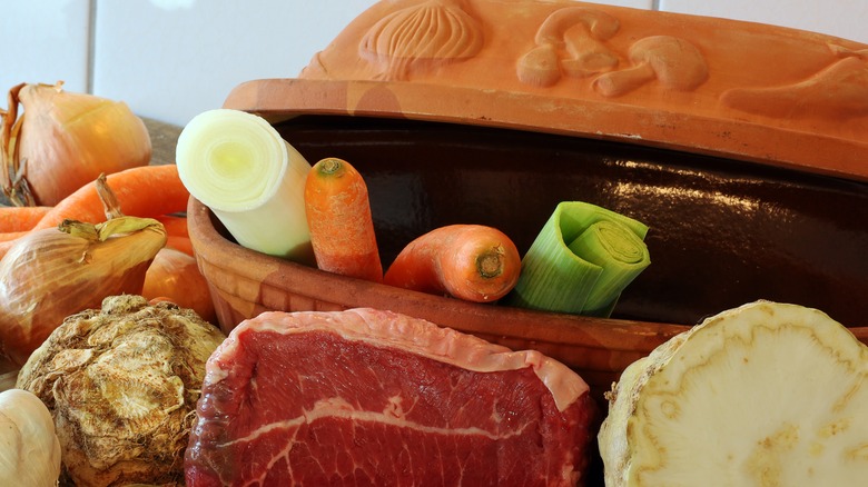 A Römertopf styled with raw ingredients