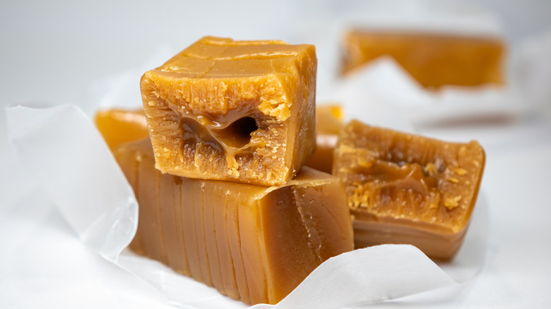 Toffee candies inside a wrapper stacked on top of one another