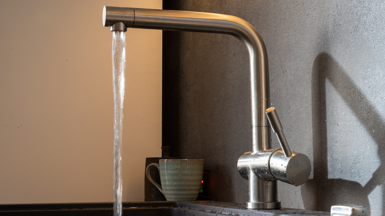 Modern-looking kitchen faucet with running water