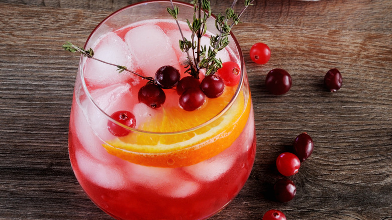 decanter of whiskey next to a blackberry smash