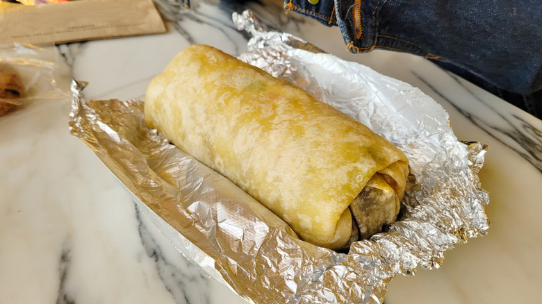 rolled burrito resting on foil