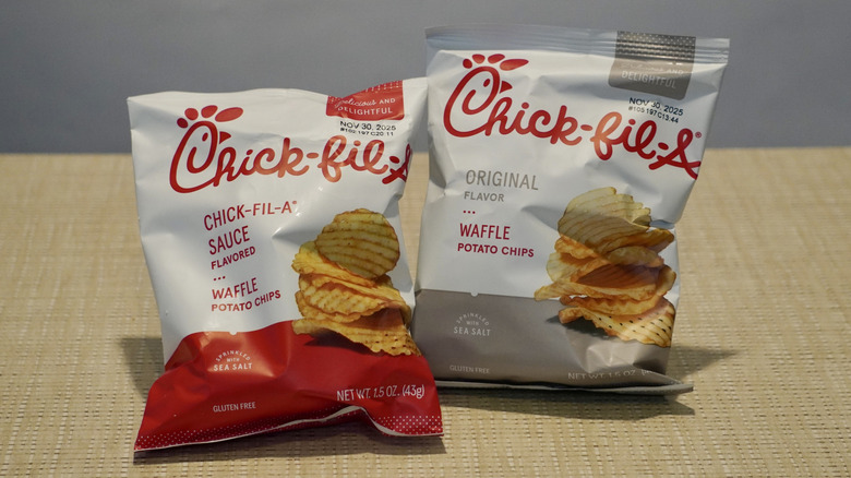 Waffle Potato Chips on a tan table in front of a white Chick-fil-A step and repeat