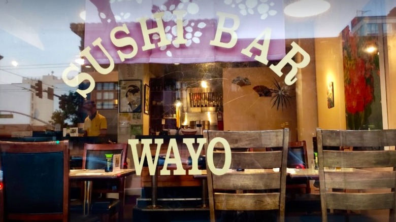 Looking through the window into Wayo Sushi, it looks cozy with wooden chairs and tables and the chef working in the back