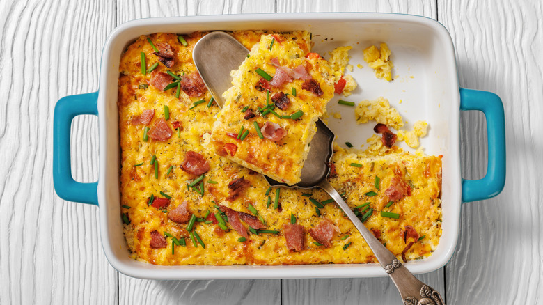 Corn pudding with meat and herbs in a baking dish.