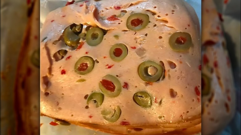 close-up of sliced olive loaf